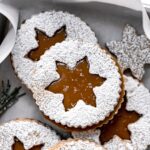 salted caramel christmas linzer cookies piled in small baking sheet