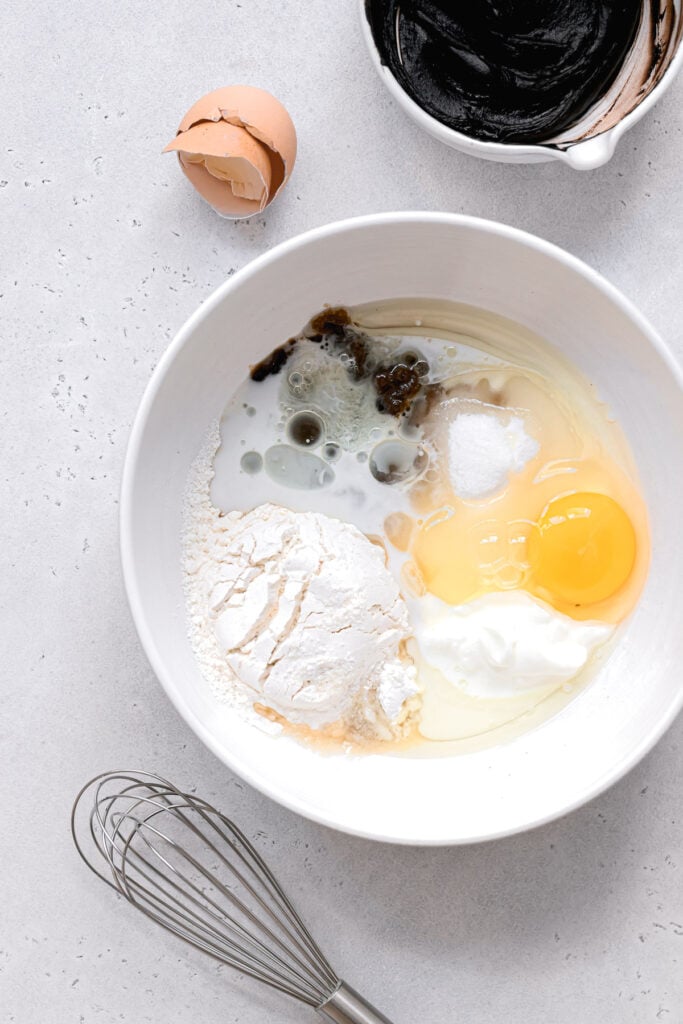 dry & wet ingredients in white mixing bowl