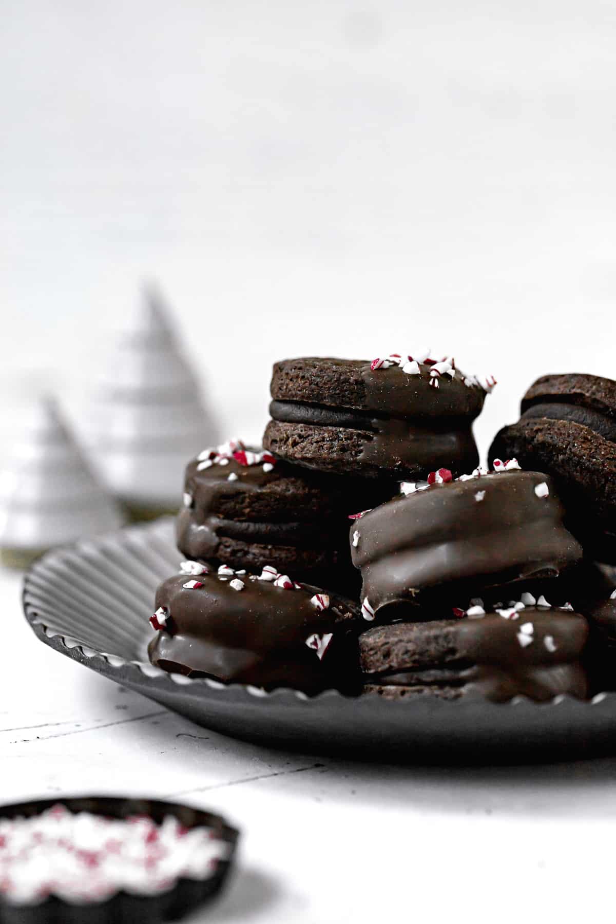 chocolate peppermint sable cookies on a black plate.