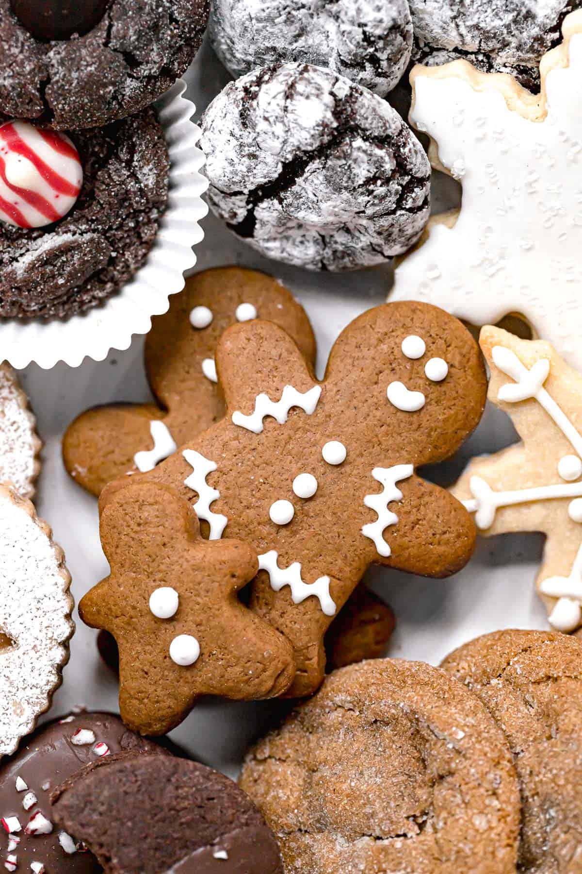 soft gingerbread cutout cookies with other festive cookies around them.
