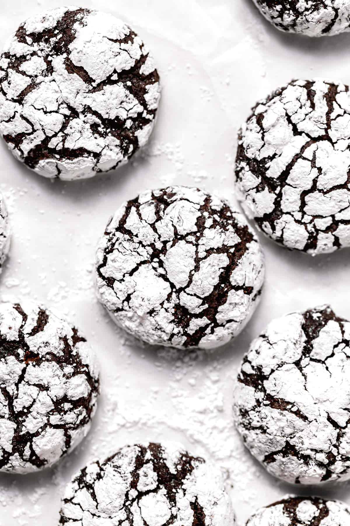 chocolate peppermint crinkle cookies on parchment paper.