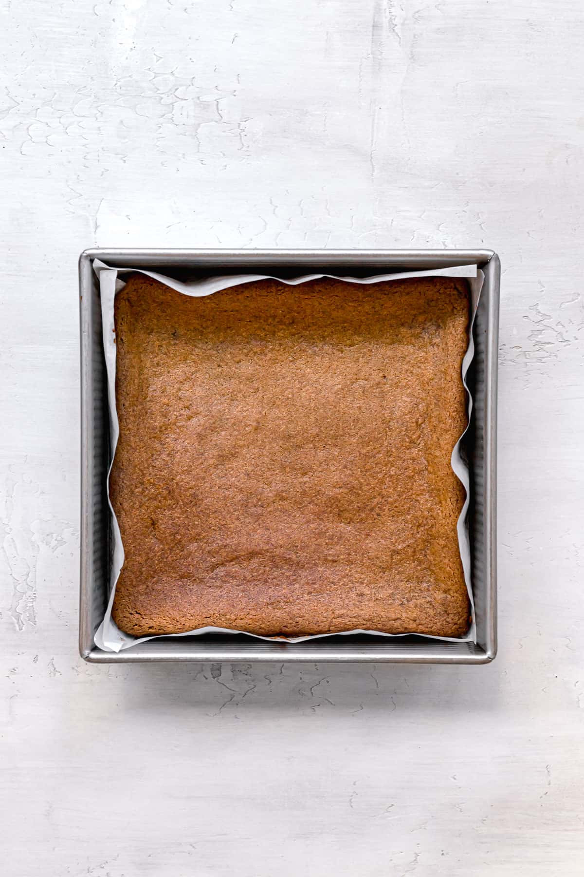 baked gingerbread blondies in metal pan.