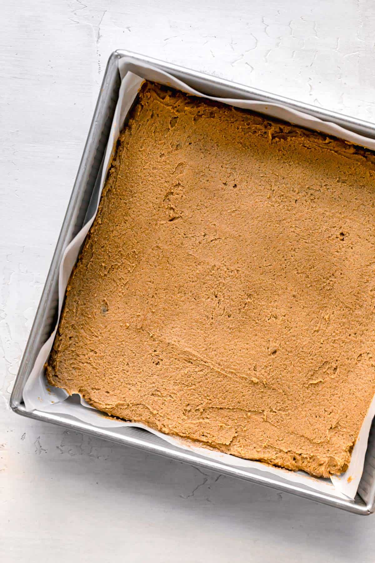 gingerbread blondie dough in metal pan.