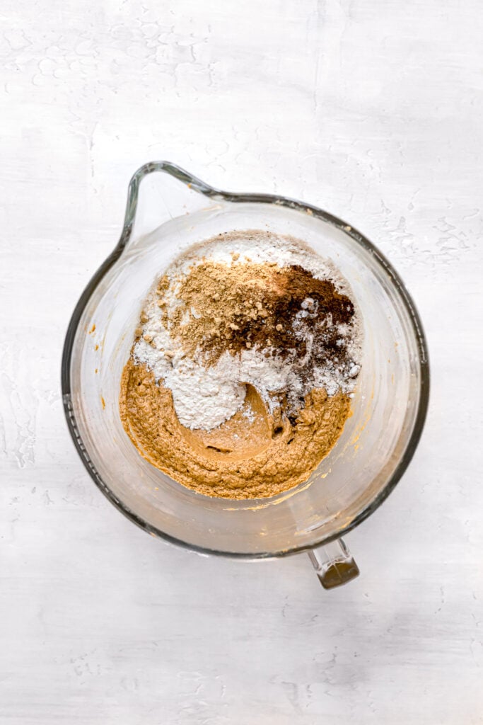 dry ingredients on top of wet ingredients in clear bowl