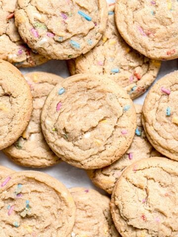 birthday cake cookies piled on baking sheet