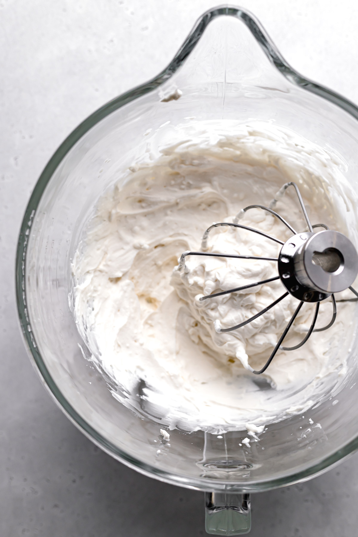 whipped cream cheese frosting in glass bowl.