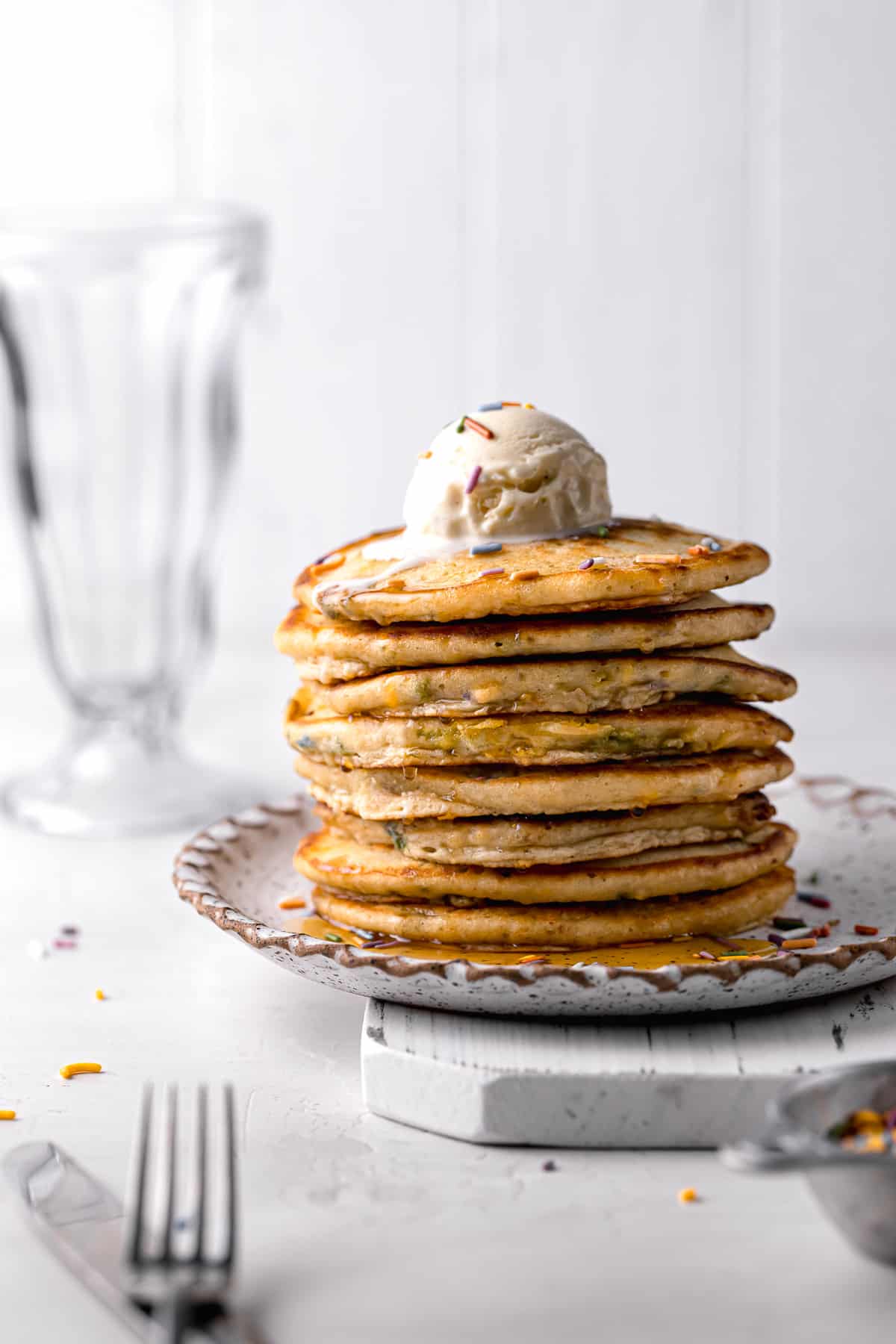 birthday recipe pancakes stacked with vanilla ice cream on top.