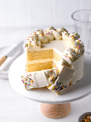 small vanilla cake recipe with swiss meringue buttercream cut to reveal interior