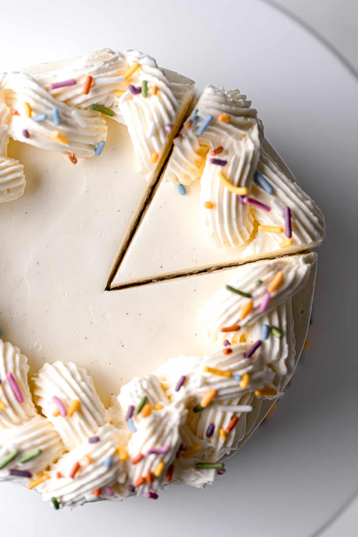 vanilla swiss meringue buttercream piped onto vanilla cake.