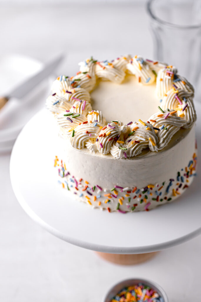 small vanilla cake with vanilla swiss meringue buttercream and rainbow sprinkles