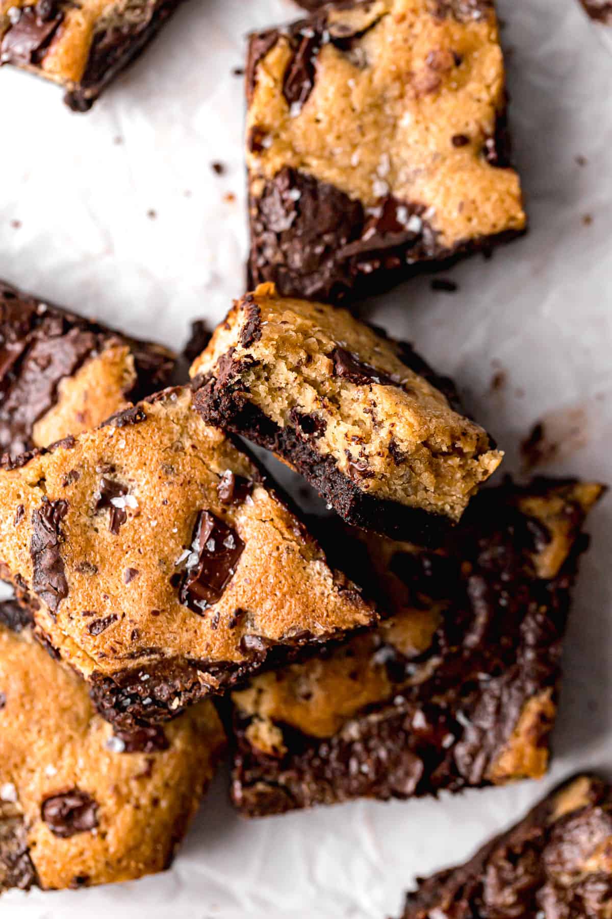 brownie blondies in a pile on parchment paper.