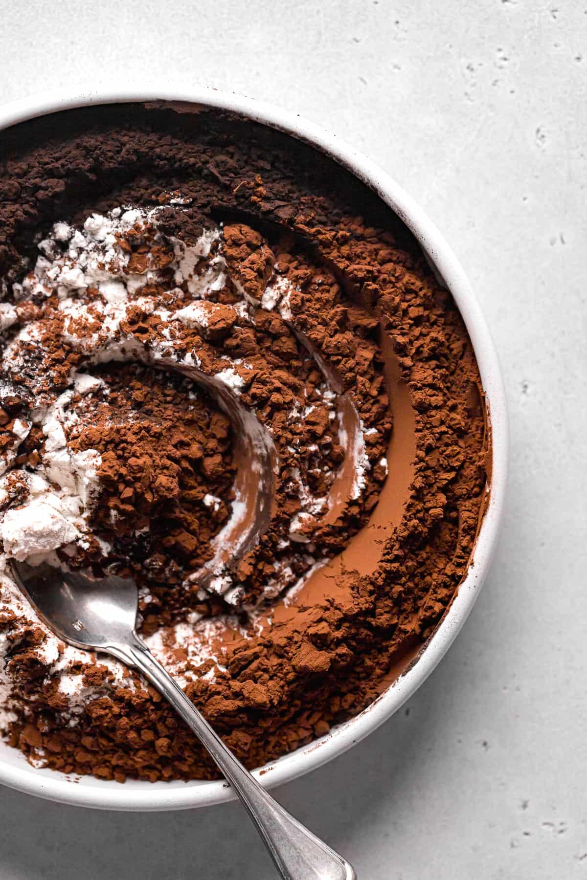 cocoa powders and flour mixed together in white bowl.
