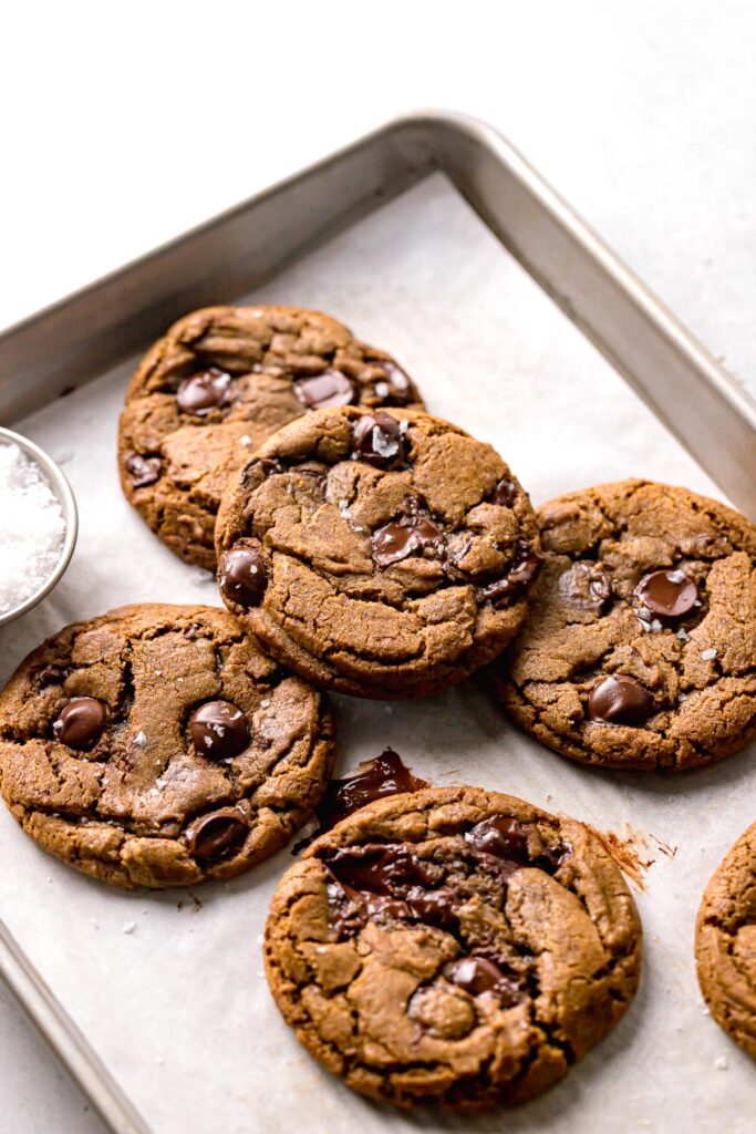 coffee cookies with chocolate chips piled on baking sheet