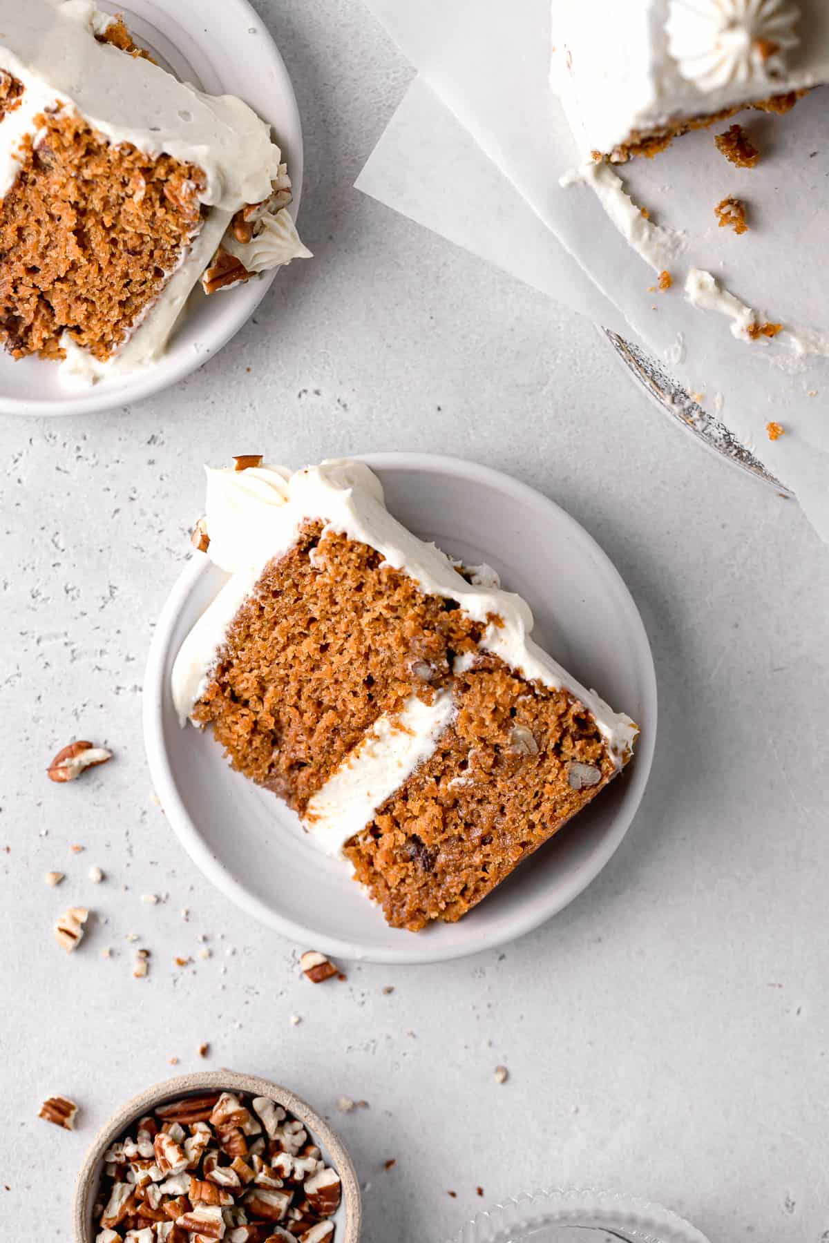 slice of small carrot cake on white plate.