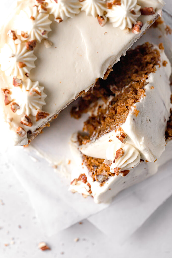 small carrot cake with two slices stacked