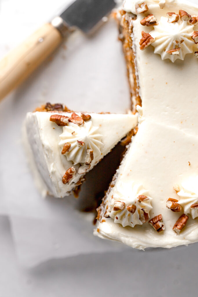 small carrot cake recipe with brown butter cream cheese frosting topped with pecans