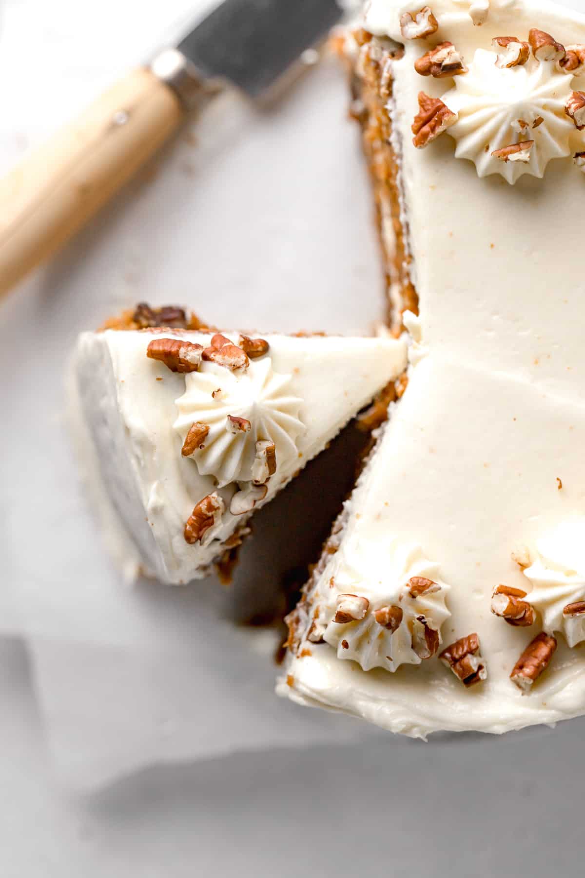 small carrot cake recipe with brown butter cream cheese frosting topped with pecans.