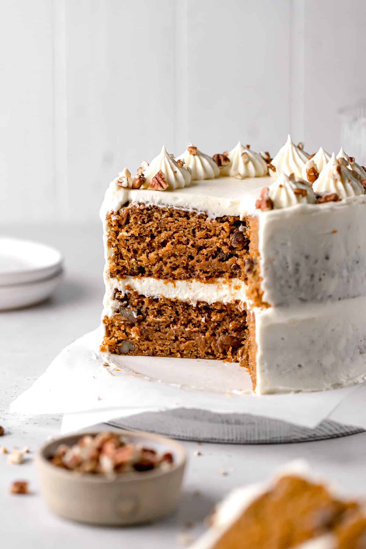mini carrot cake with brown butter cream cheese frosting cut to reveal inside.