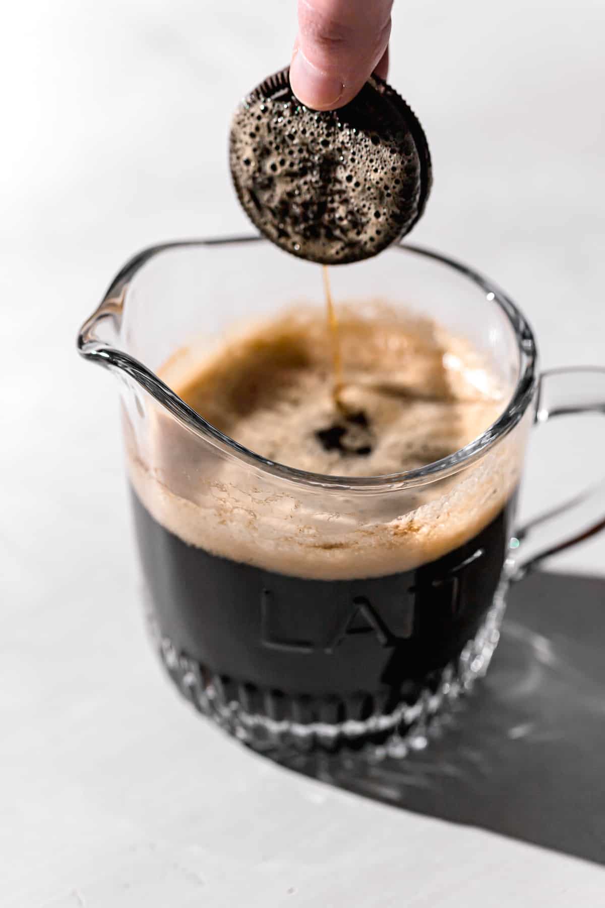 oreo being dipped in coffee.