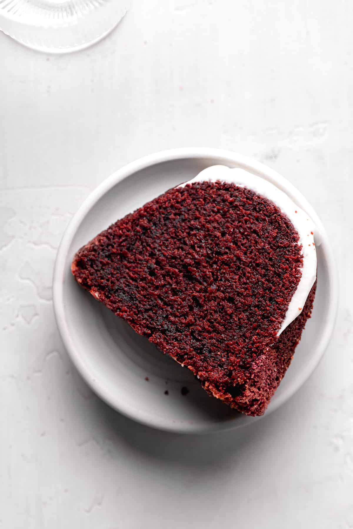 red velvet bundt cake slice on white plate.