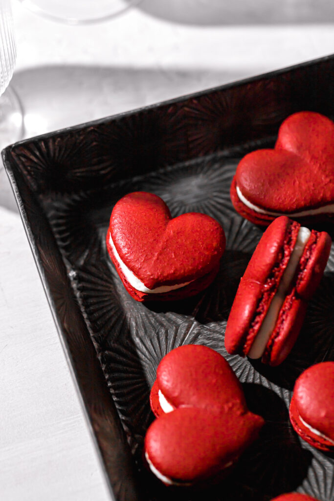 swiss method macarons colored red in metal tray