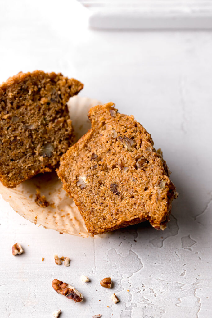 banana carrot muffin cut in half to show inside texture