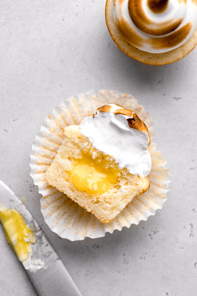 lemon meringue cupcake cut in half to show lemon curd