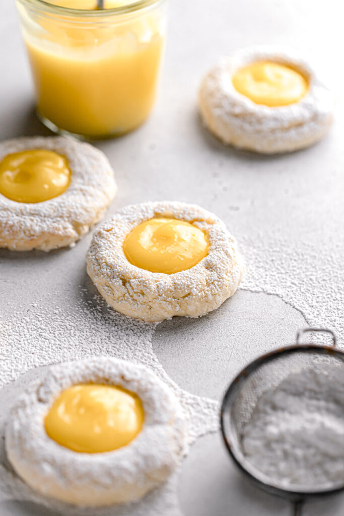 cream cheese cookies dusted with powdered sugar and filled with tart lemon curd