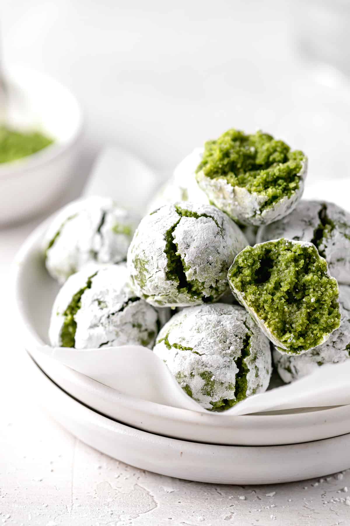 matcha cookies piled on white plate.