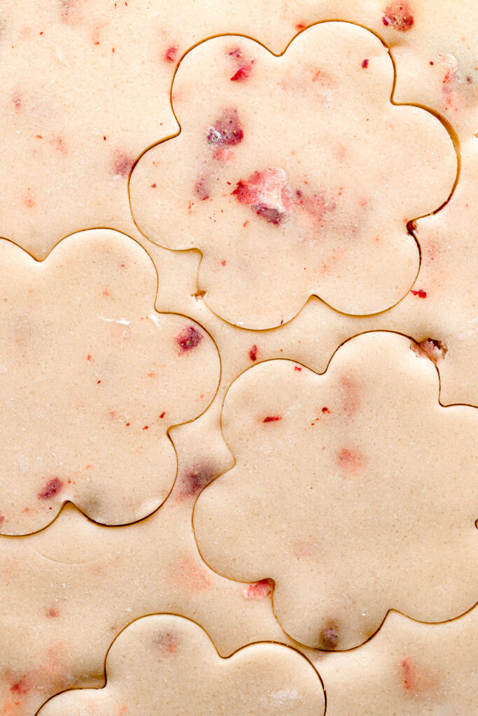 freeze dried strawberry cookie dough rolled out with flower cookie cutouts