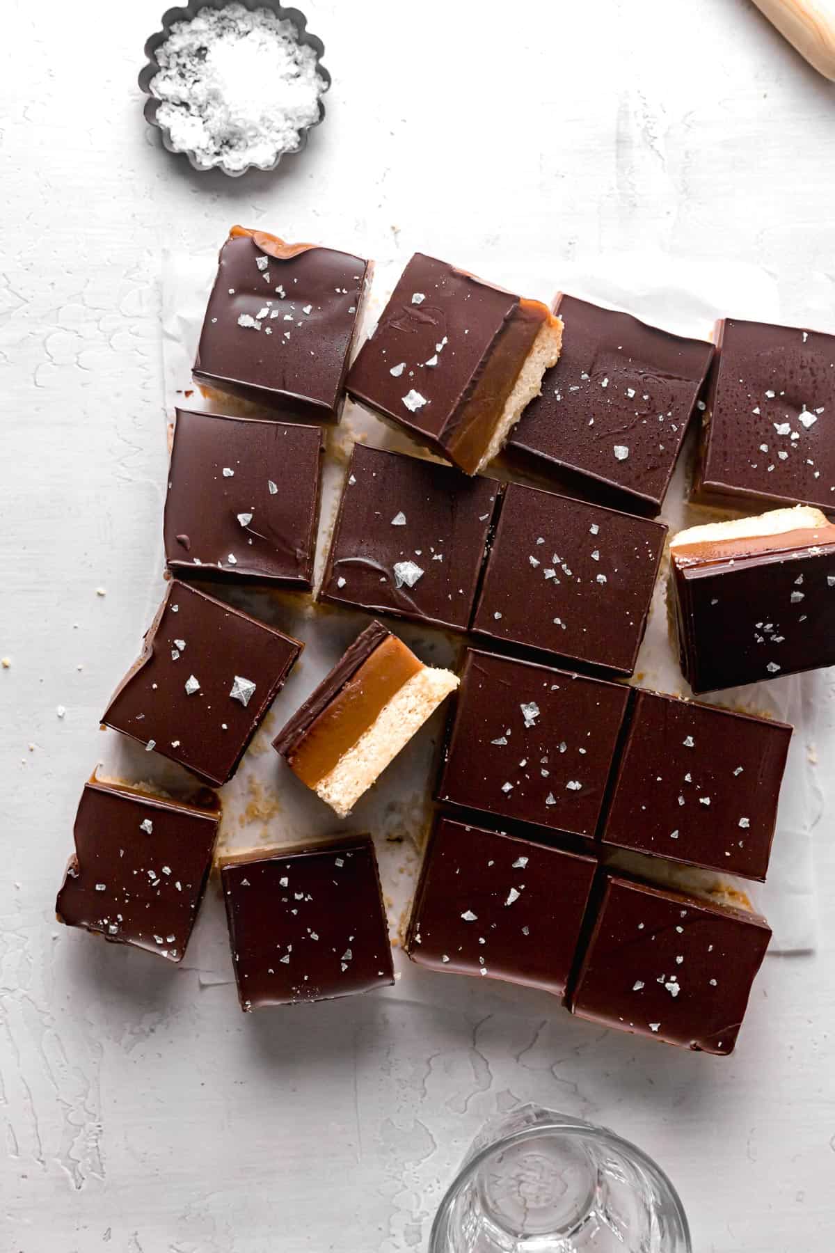tahini caramel millionaire's shortbread cut into 16 squares with some turned on their sides.