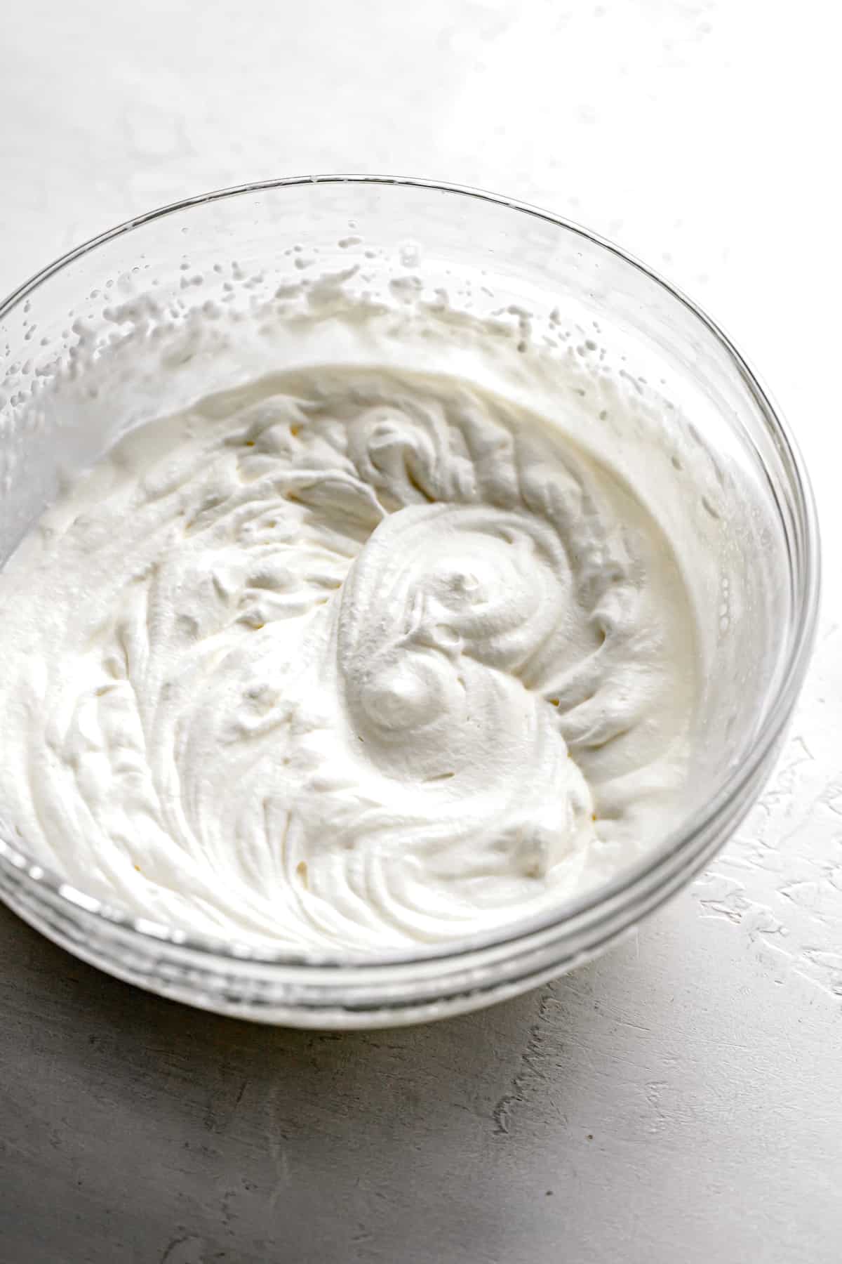 whipped cream in glass bowl.