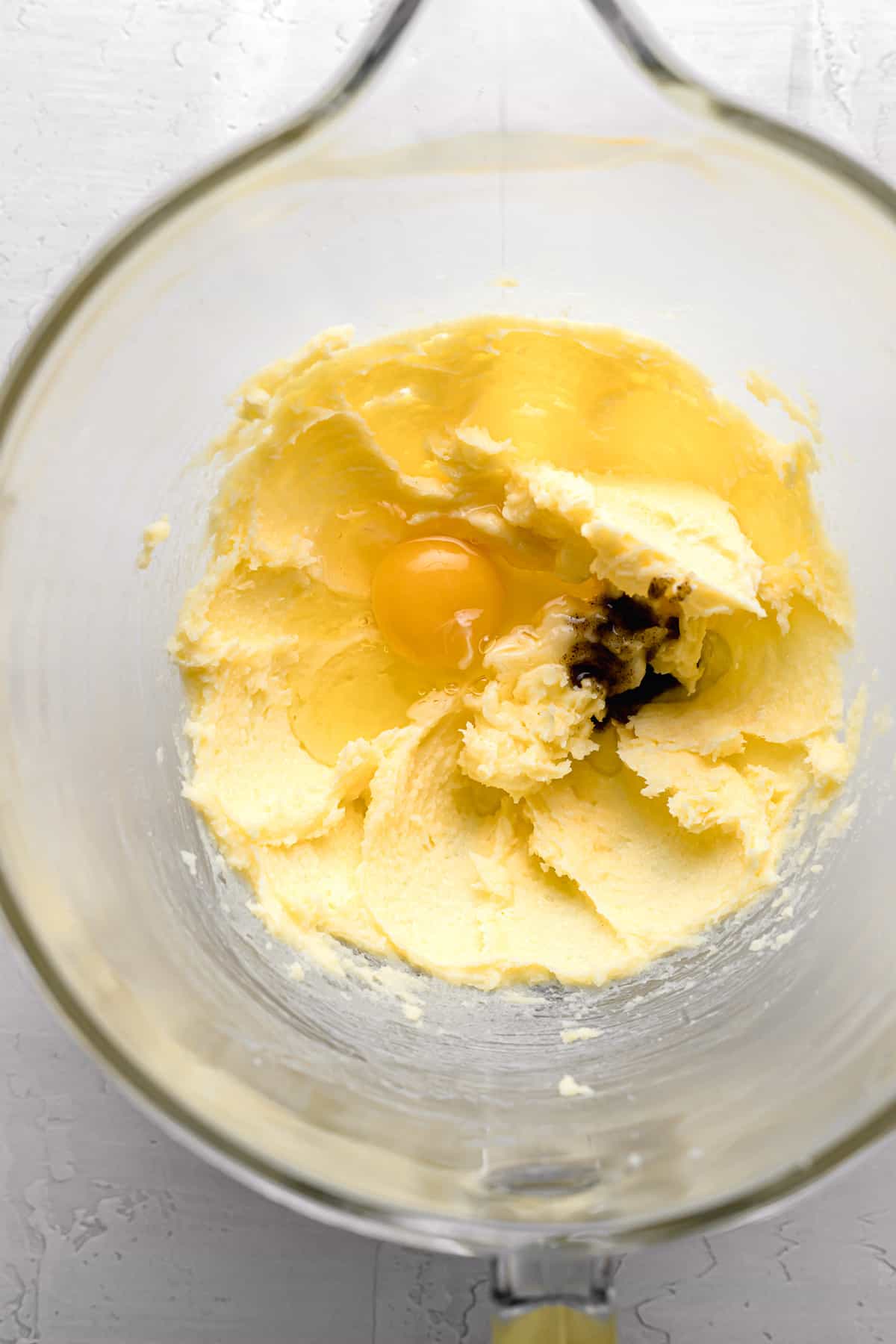egg and vanilla added to butter-sugar mixture in glass bowl.