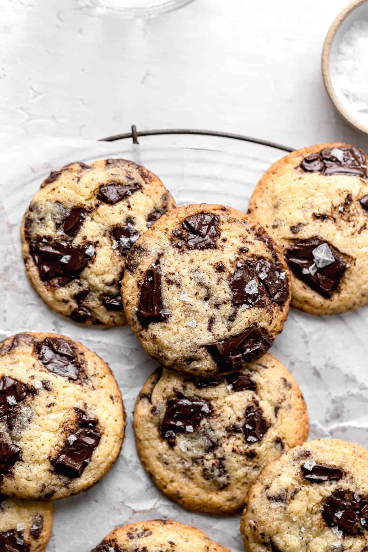 chocolate chip cookies without brown sugar piled on parchment lined wire rack.