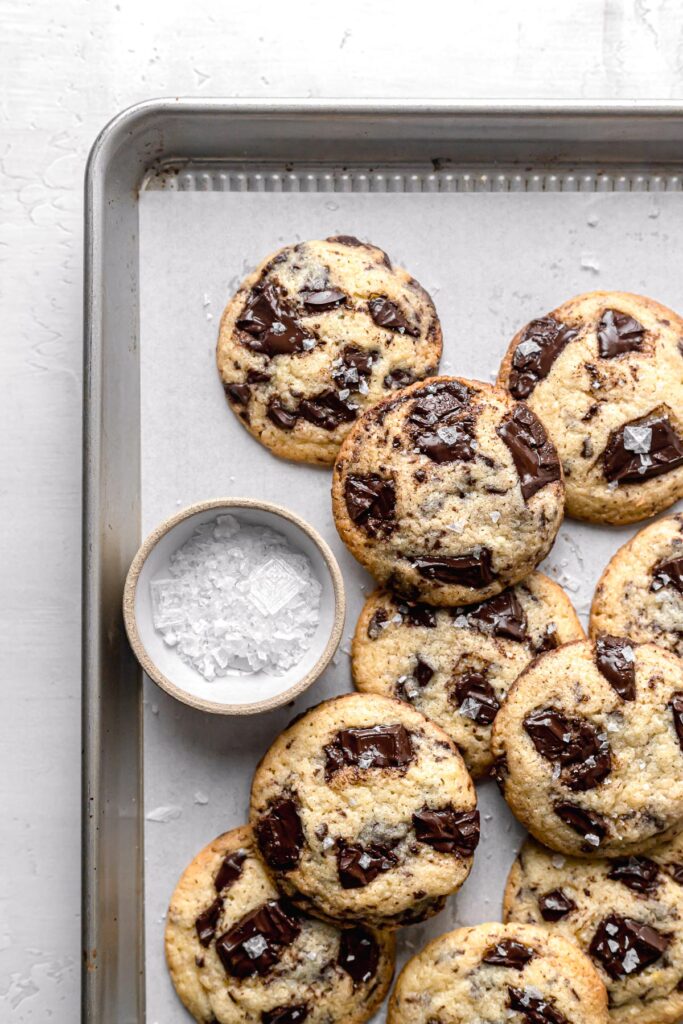 chocolate chip cookies without brown sugar piled on baking sheet
