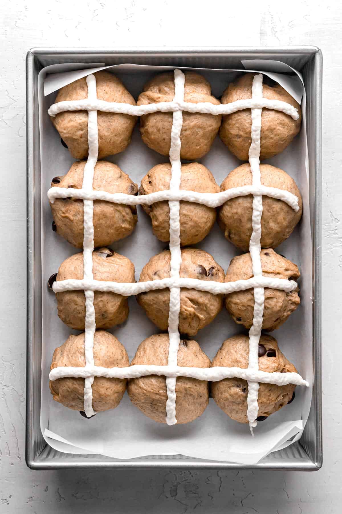 unbaked hot cross buns in 9x13 pan.