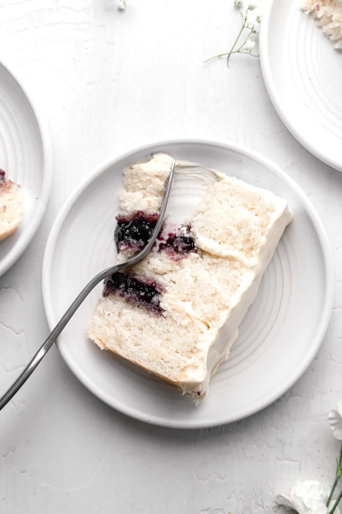 slice of blueberry jam cake on white plate.