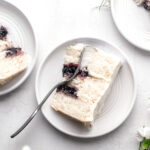 slice of lemon blueberry jam cake on white plate with fork