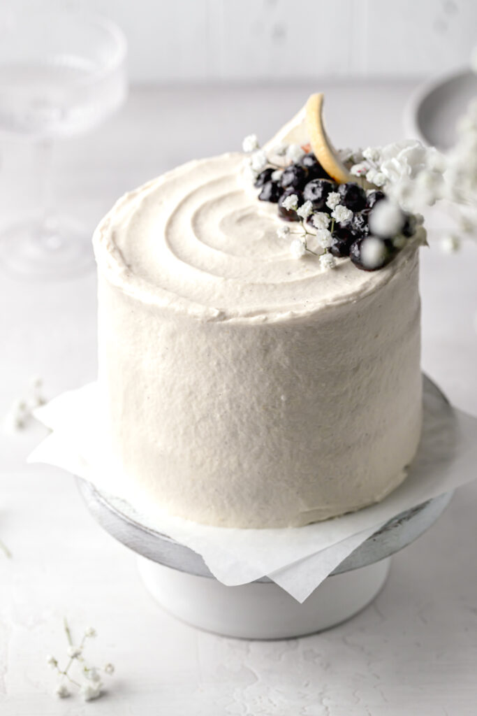 lemon blueberry jam cake with cream cheese german buttercream on white cake stand