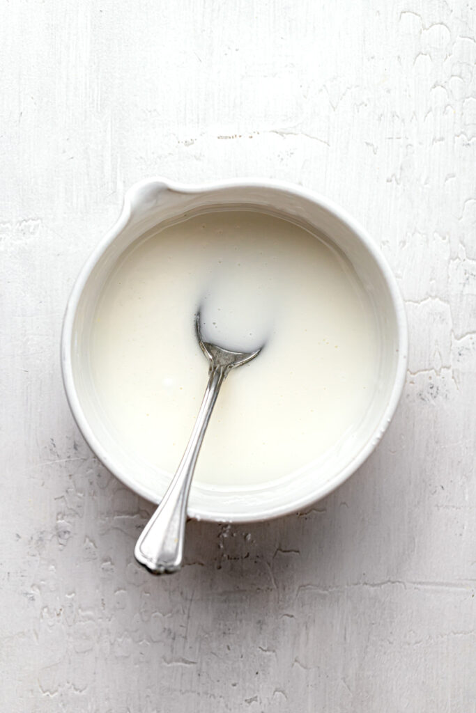 lemon glaze in white bowl with spoon