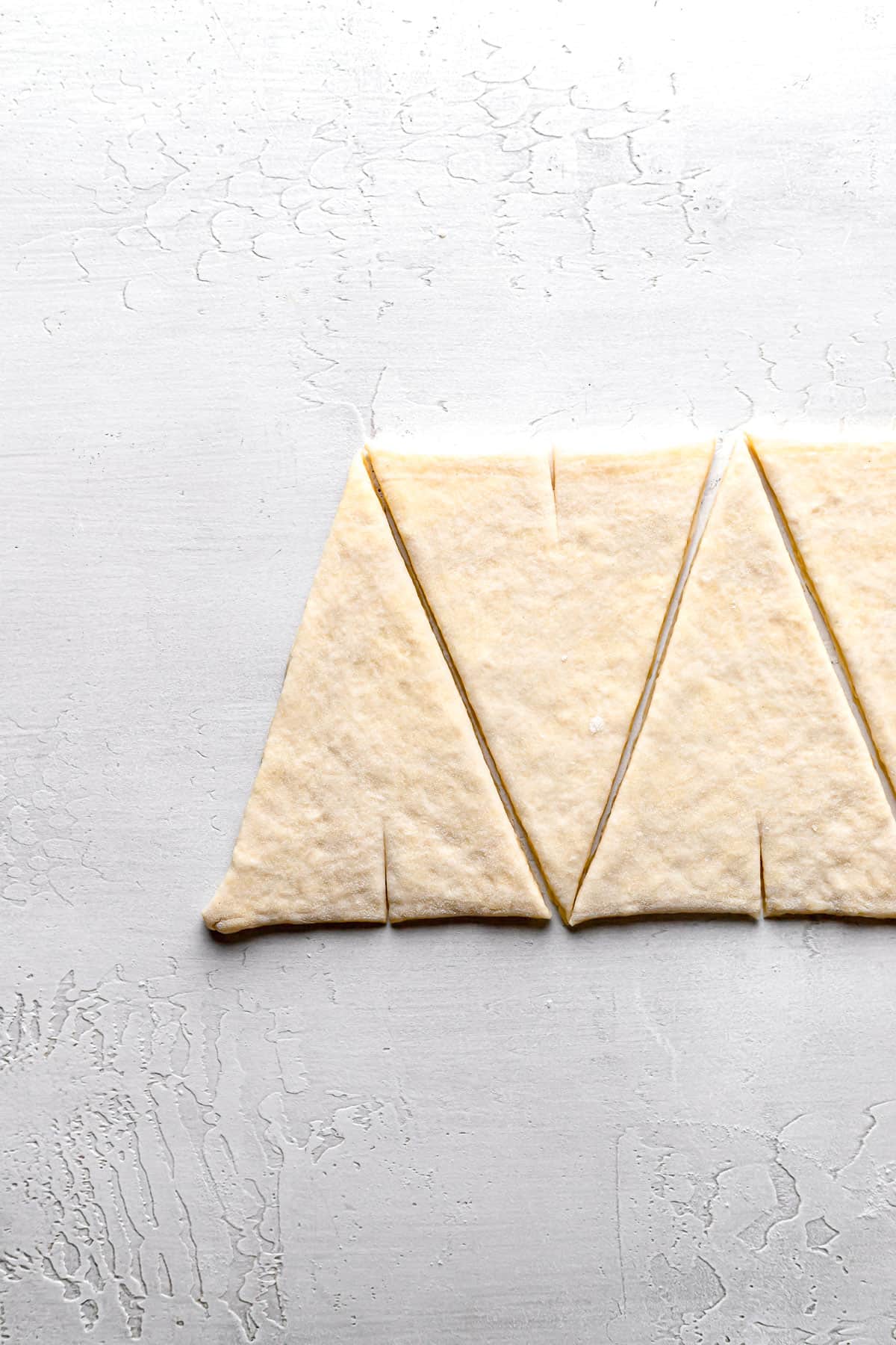 croissant dough cut into triangles.