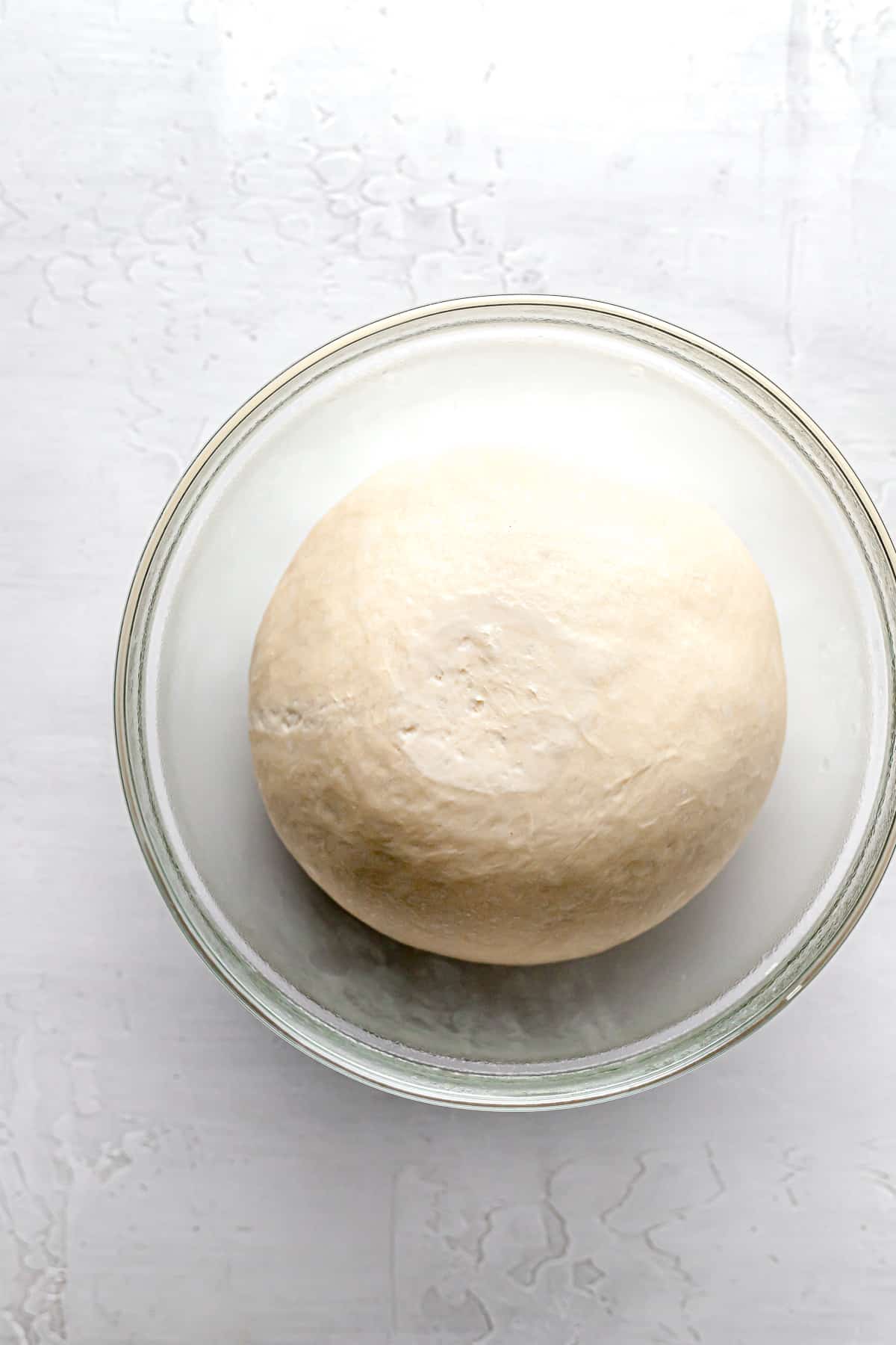 croissant dough in glass bowl.
