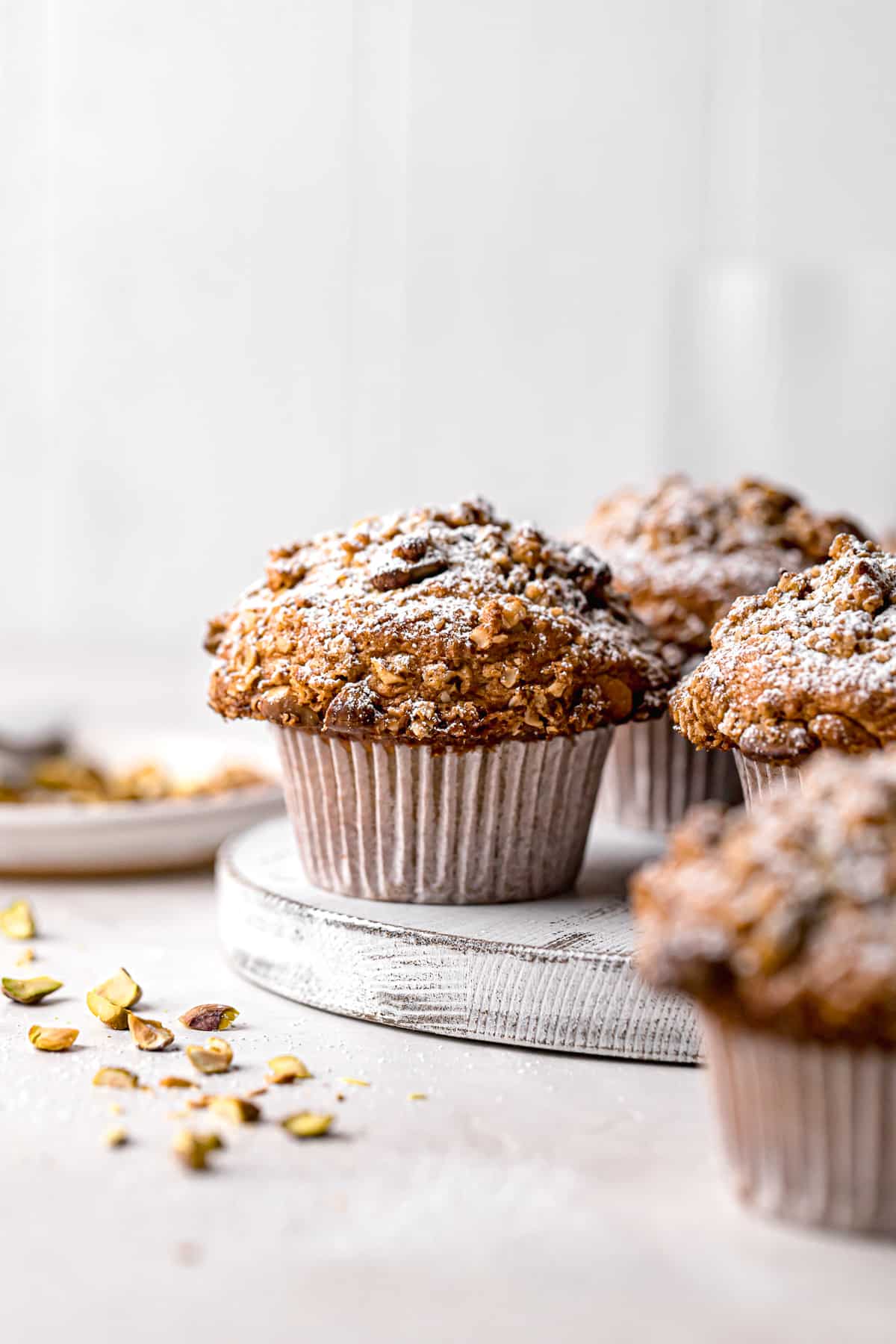pistachio muffins with oat streusel on white board.