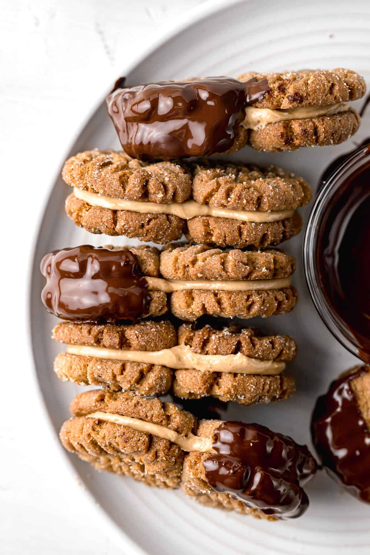 peanut butter sandwich cookies lined up on white plate