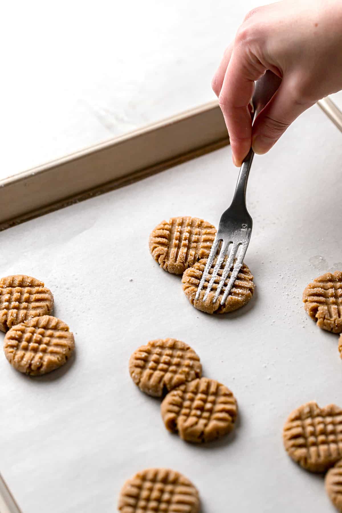 fork indentations being made in cookie dough