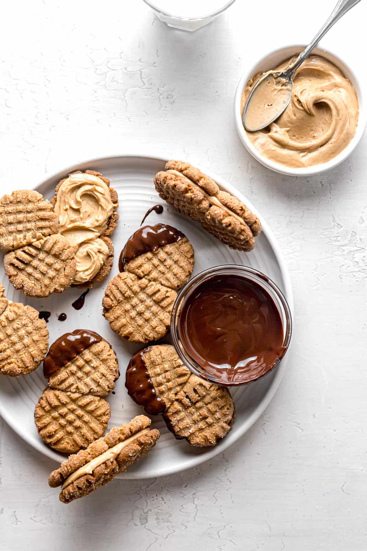 small batch peanut butter cookies dipped in chocolate on white plate.