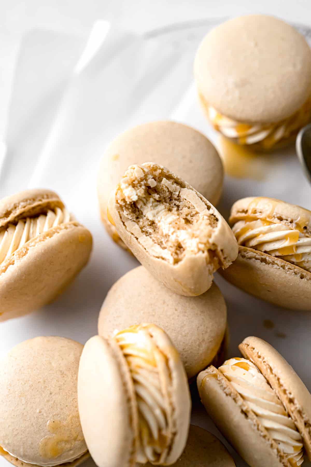 salted caramel macarons with bite taken out of one
