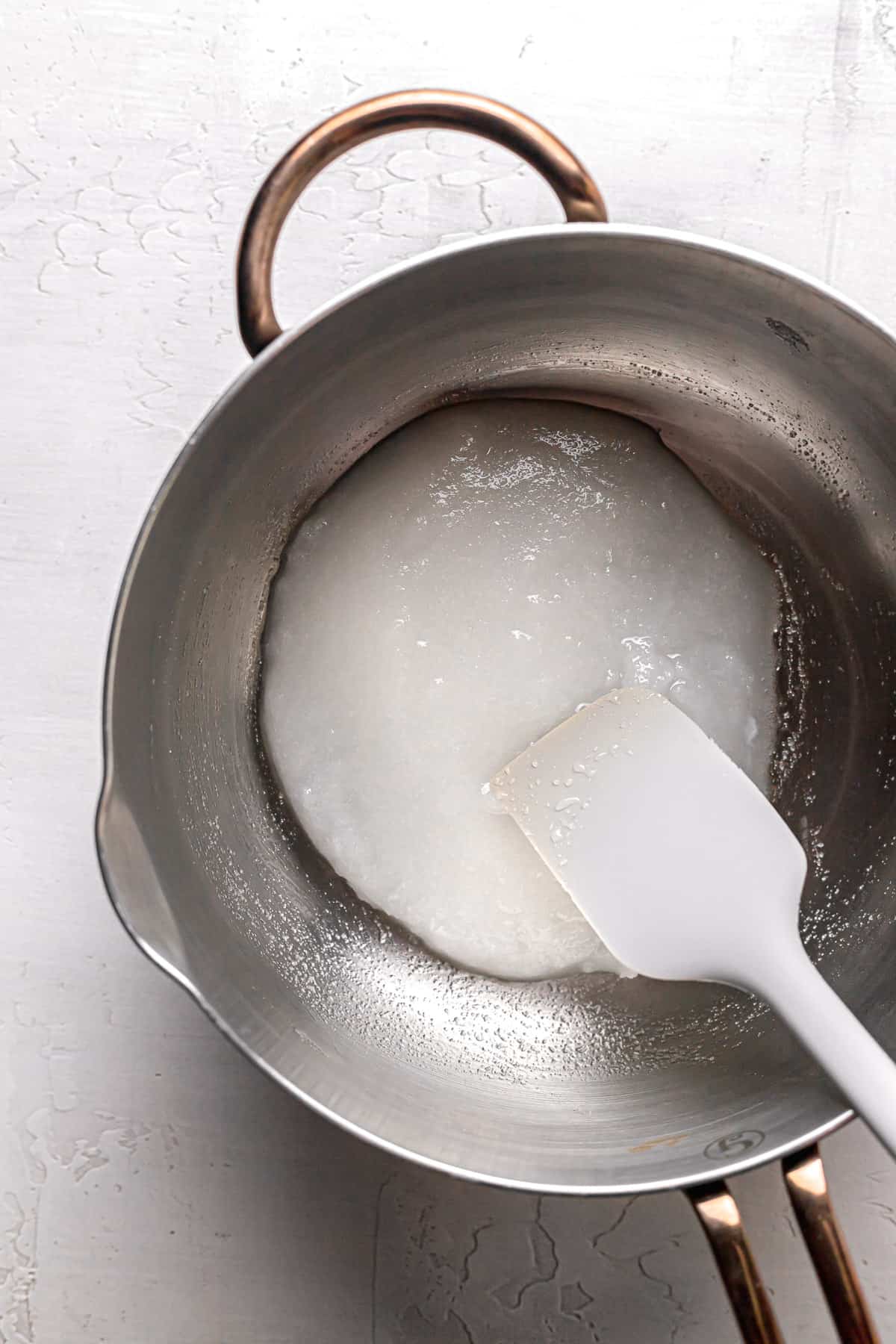 water fully mixed into into sugar mixture in saucepan