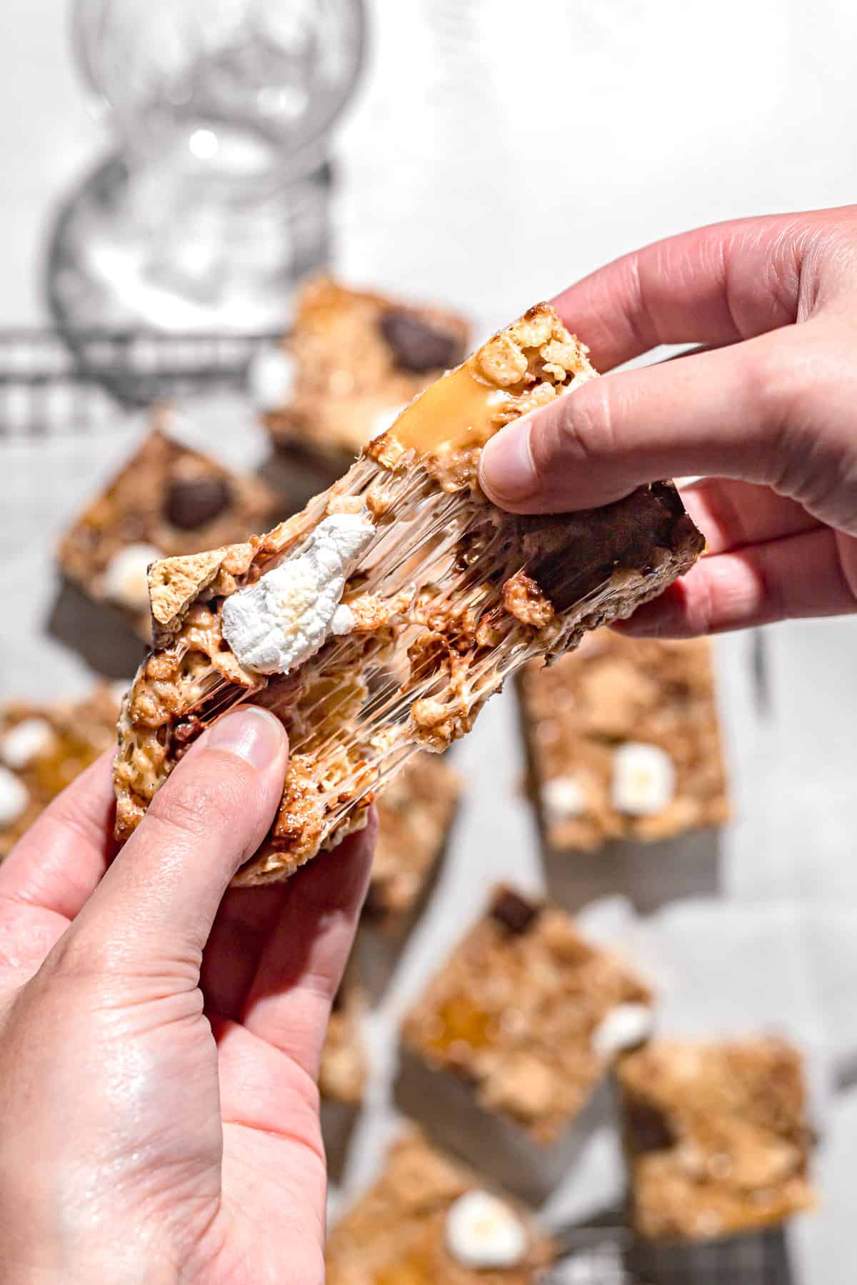 one caramel s'mores rice krispie treat being pulled apart.