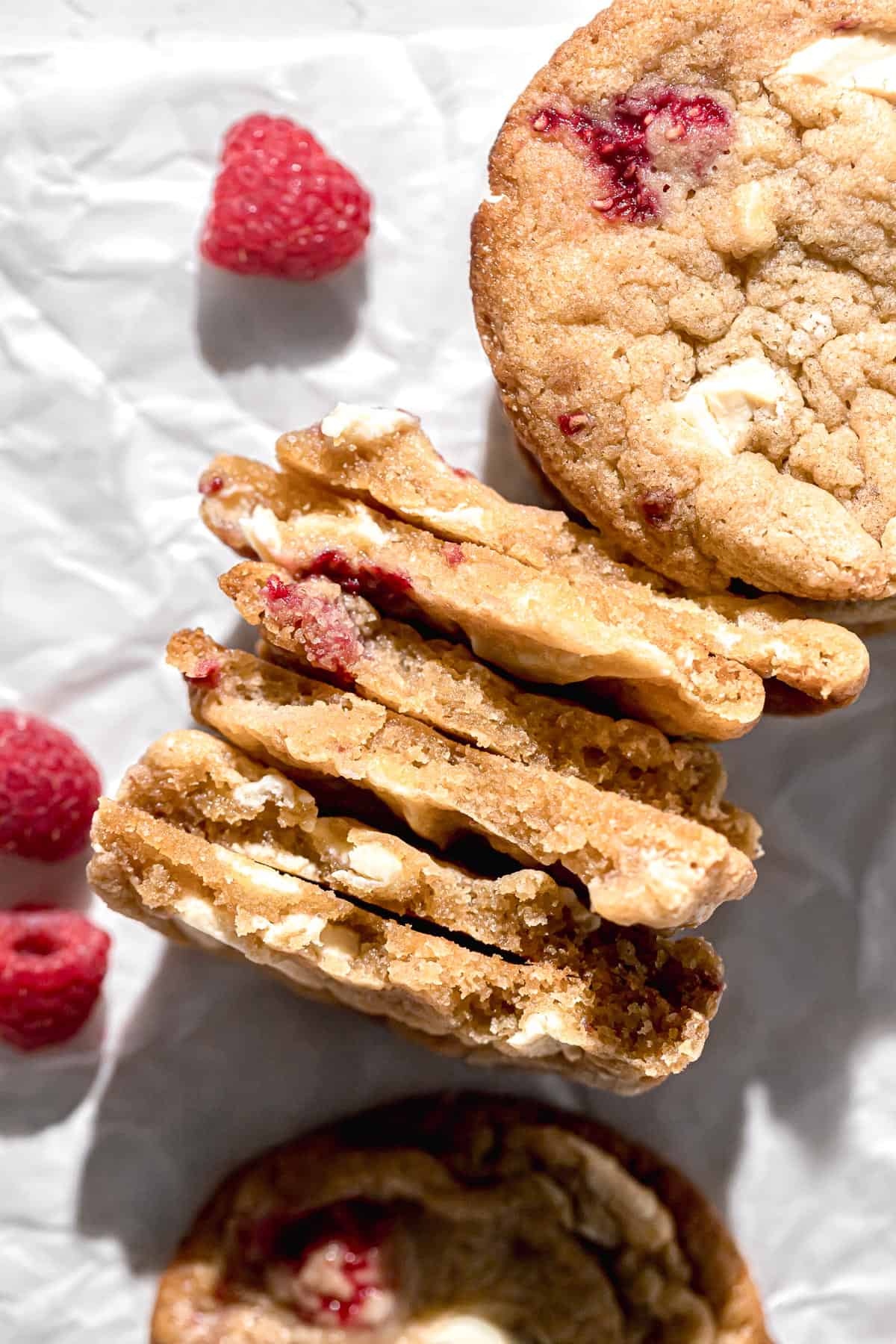 raspberry white chocolate cookies broken in half to show inside texture